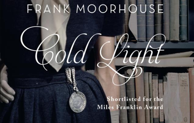 Woman in elegant clothing standing in front of bookshelves for book cover Coldlight by Franke Moorhouse