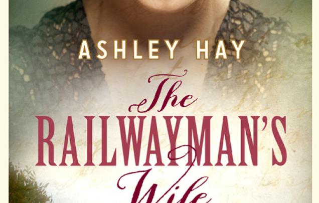 Woman wearing a hat looking down with image of a coast line below on book cover of The Railwayman's Wife by Ashley Hay