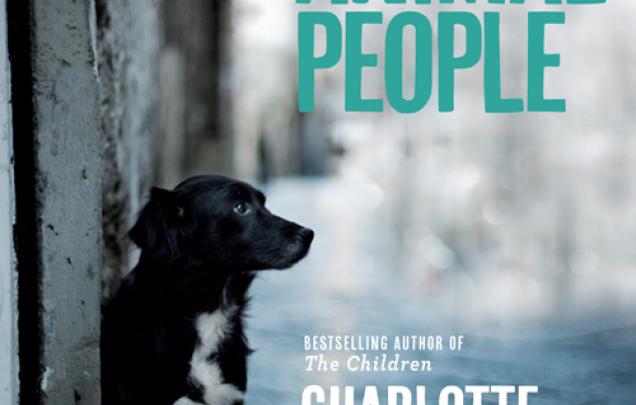 Dog sitting near a door in a street on book cover for Dog People by Charlotte Wood