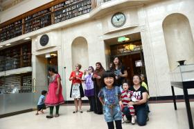 A group of children and adults on a Library tour. 