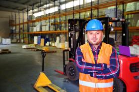 Man in hard hat standing in a warehouse