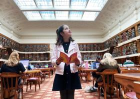 Young girl with book in Mitchell Library Reading Room