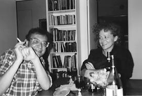 Black and white photo of Sasha and Inez sitting at a table