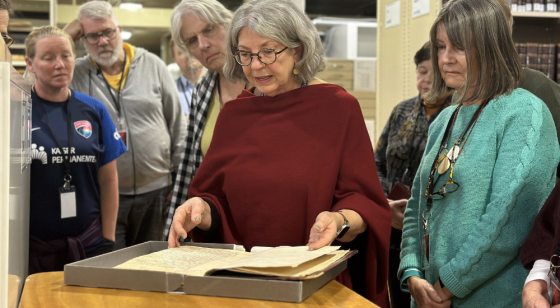 Tour guide showing group rare book
