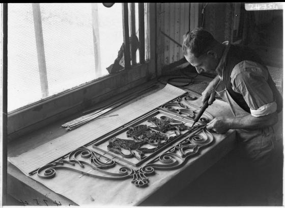 Man crafting mosaic map for the State Library