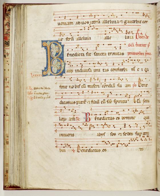 A page of a medieval looking manuscript with lines of music accompanied by Latin lyrics.