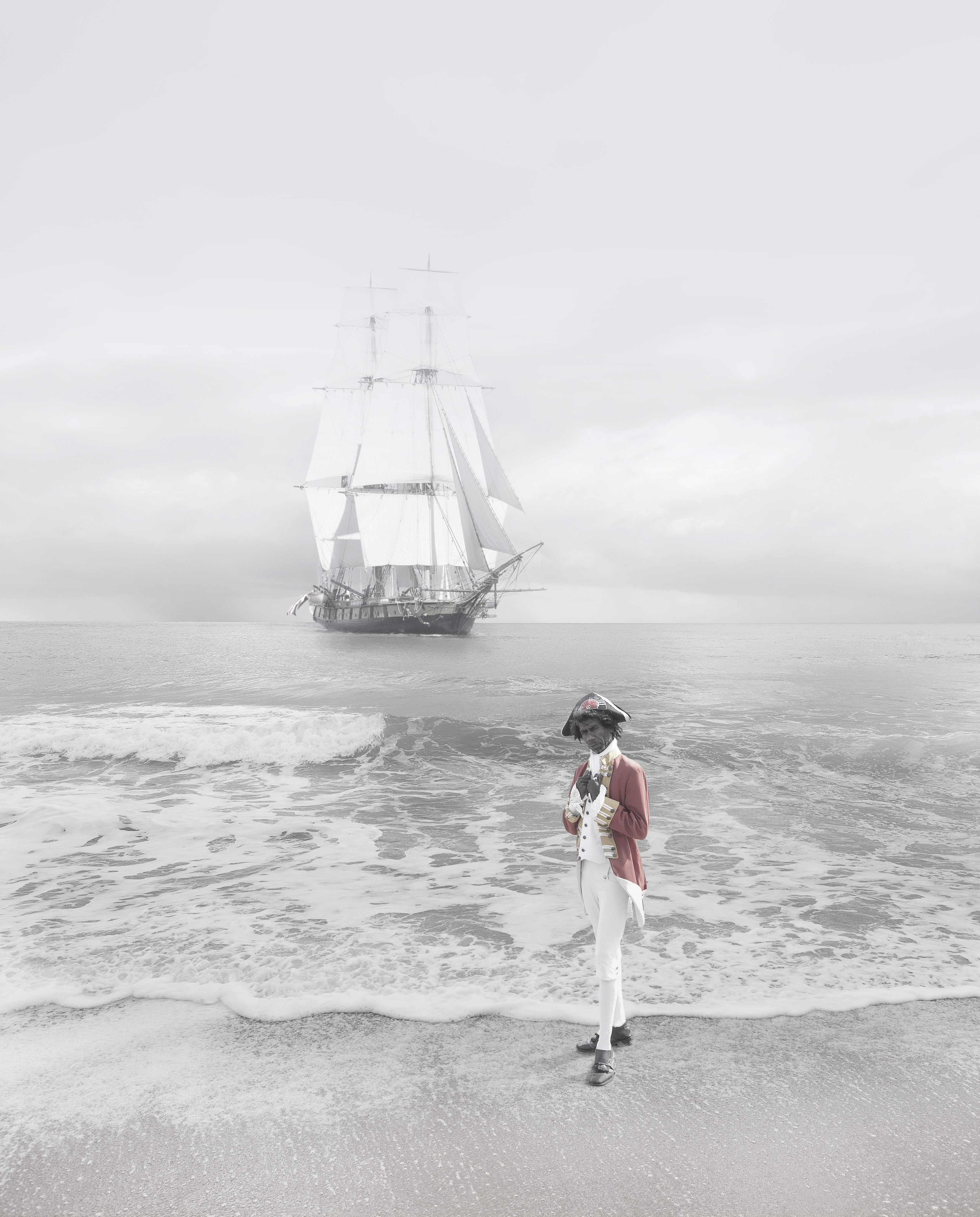 Composite image of an Aboriginal man in British naval dress on the beach, and a sailing ship in the ocean in the background.