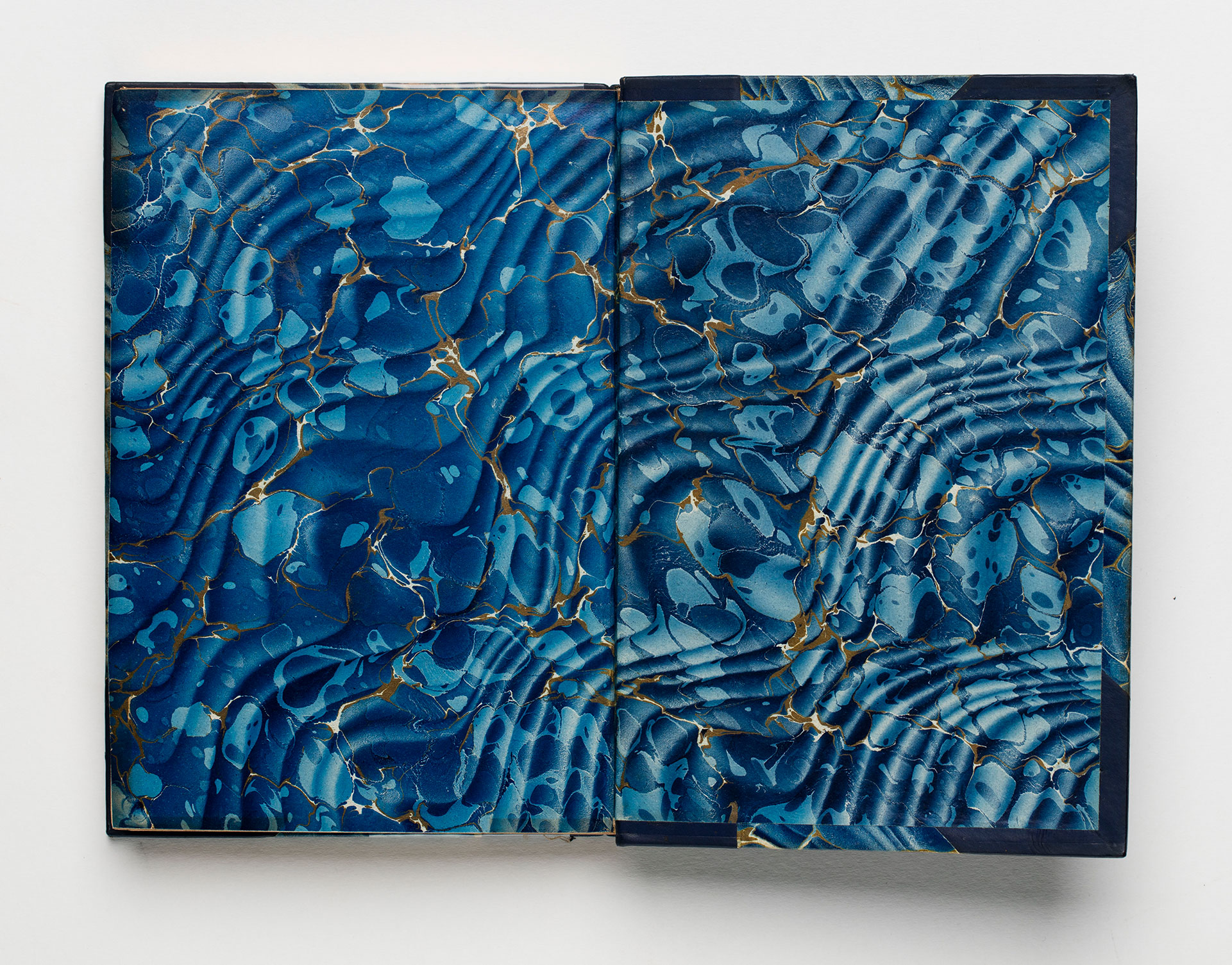 An endpaper patterned in ripples of blue and gold.