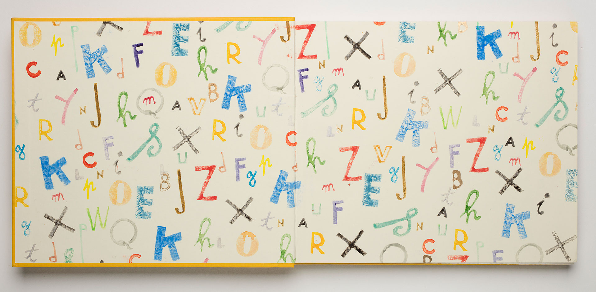 Endpapers with illustrated, colourful letters of the alphabet in various styles.