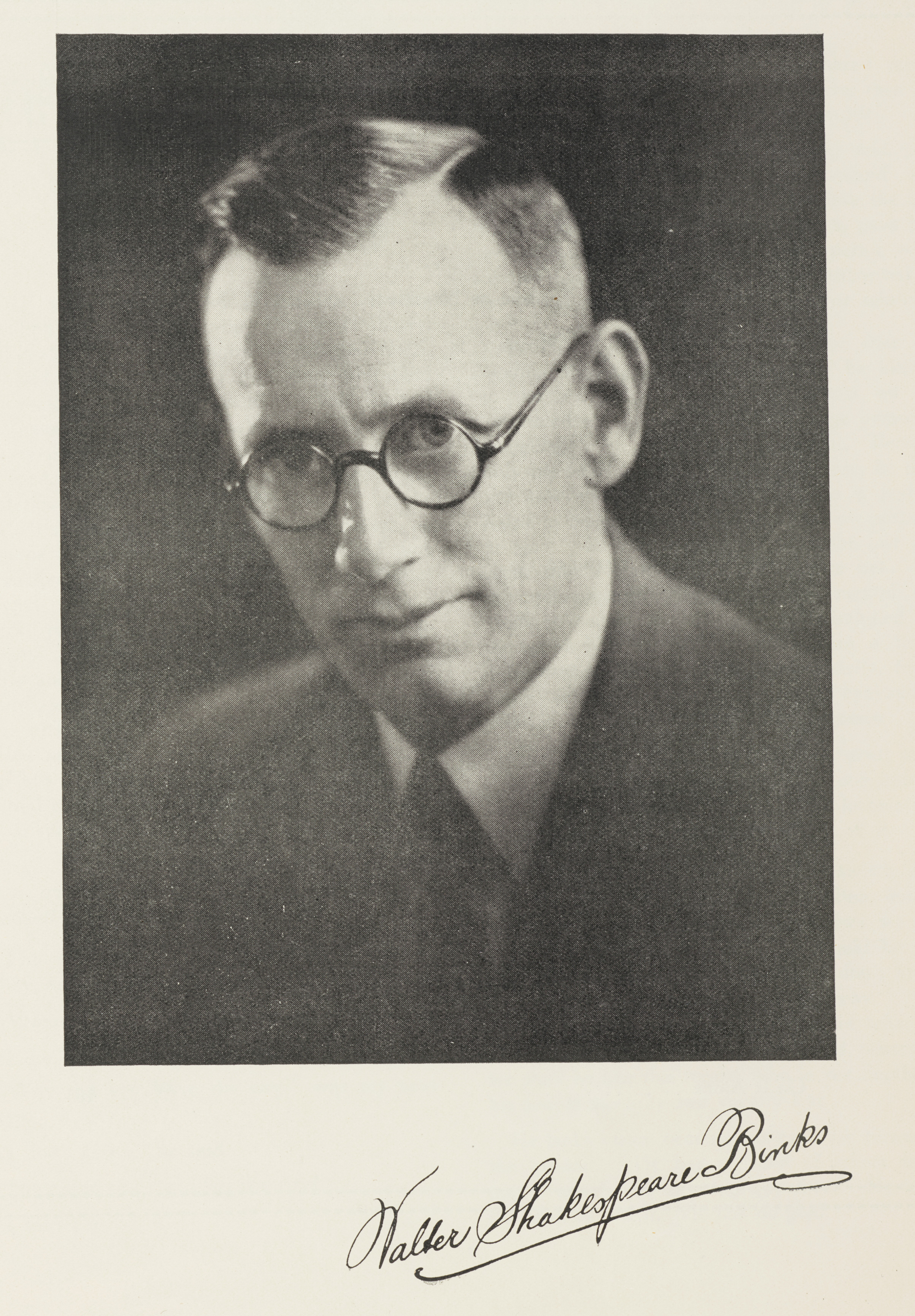Black and white portrait photograph of a man wearing glasses.  