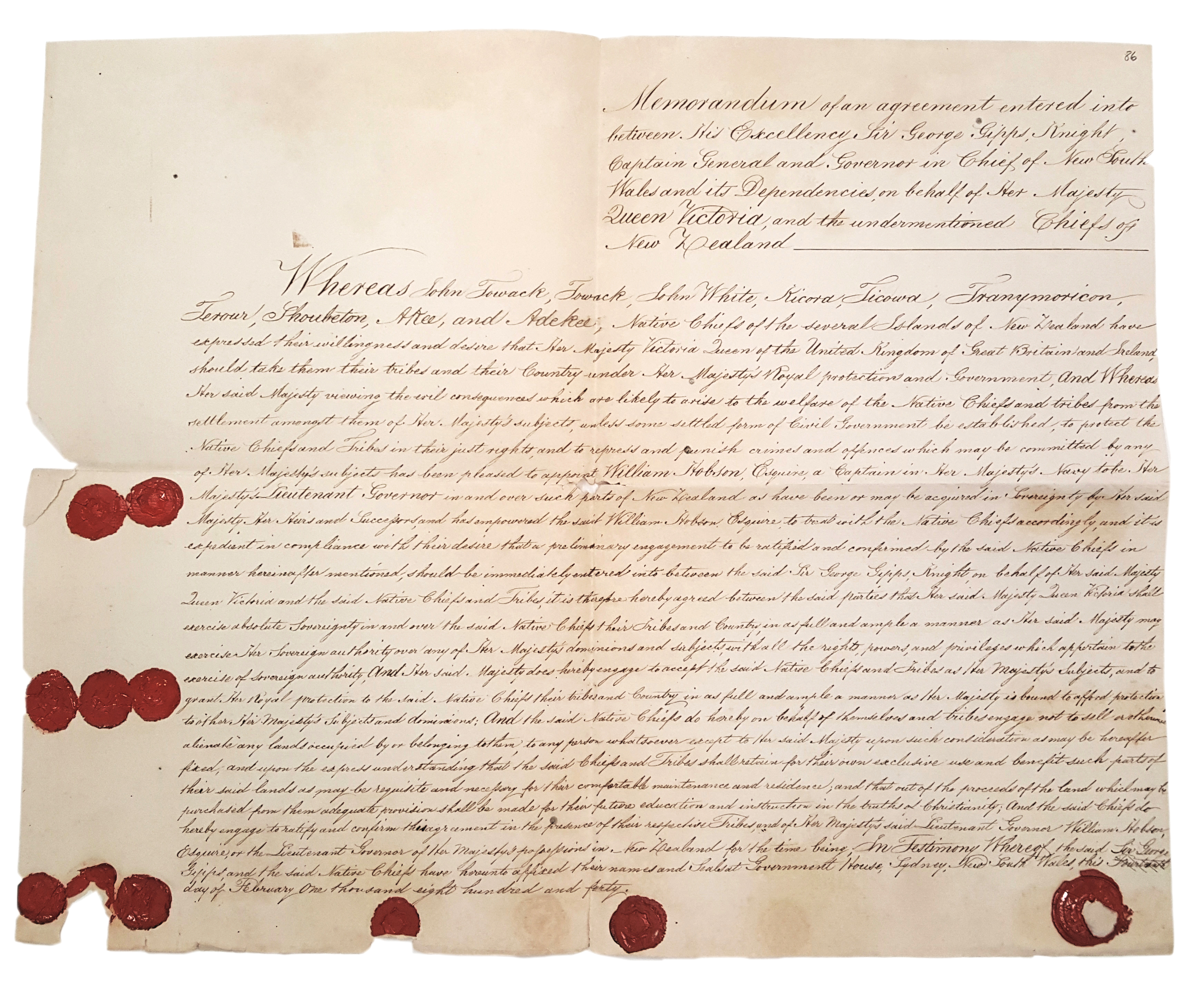 Elaborate running writing covers this aged document. Marks of broken dark red wax seals mark the bottom and left side edges of the document. 