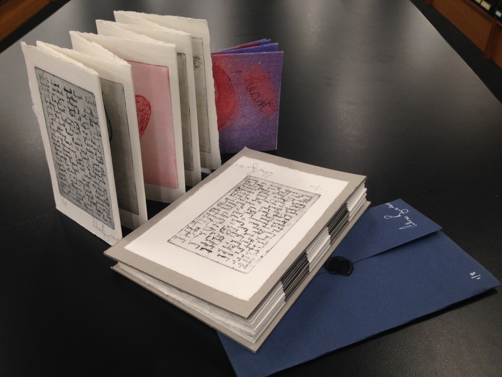 Four artists' books shown together on a table