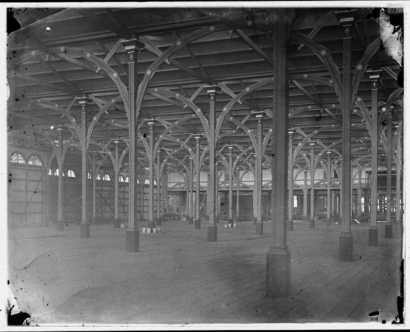 Empty interior of Garden Palace Sydney showing wooden beams and pillars