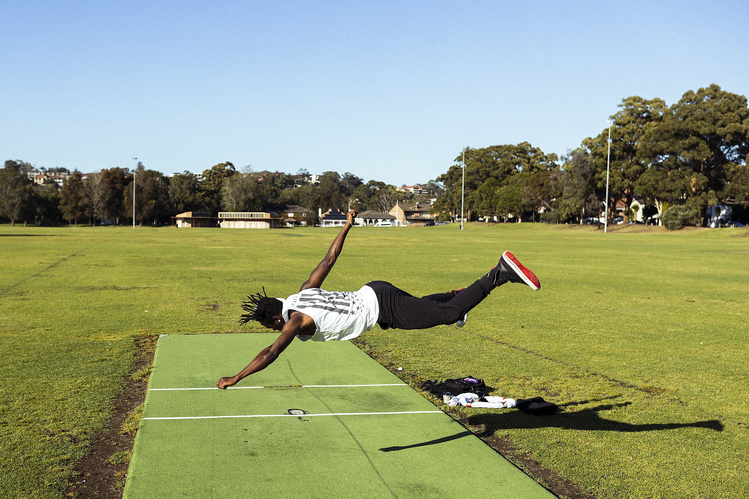 Dancer and choreographer Lucky Lartey dances on a cricket pitch at Beaman Park in Earlwood during a COVID-19 lockdown in Sydney  in September 2021. Photo by Dominic Lorrimer