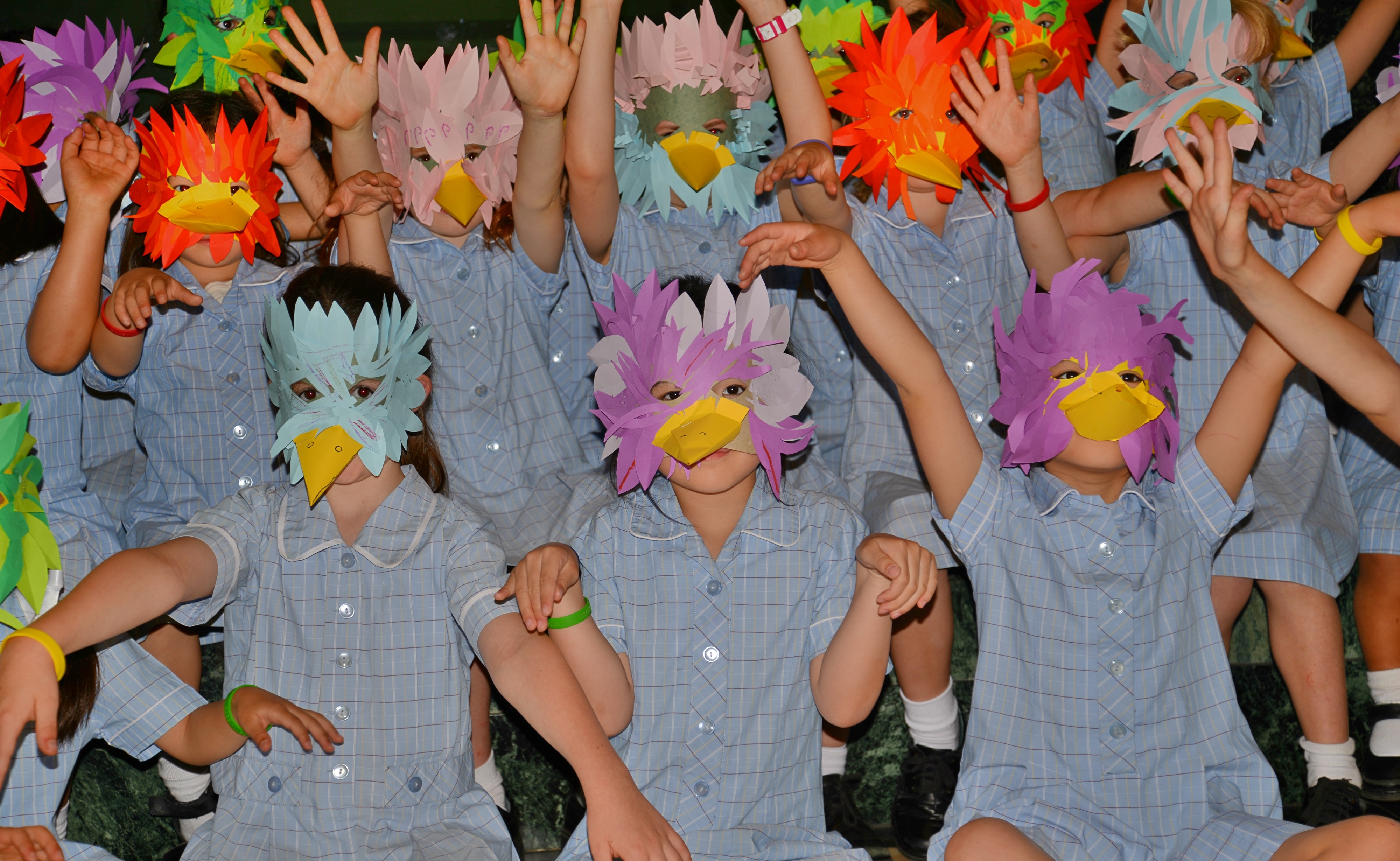 group of students wearing bird masks