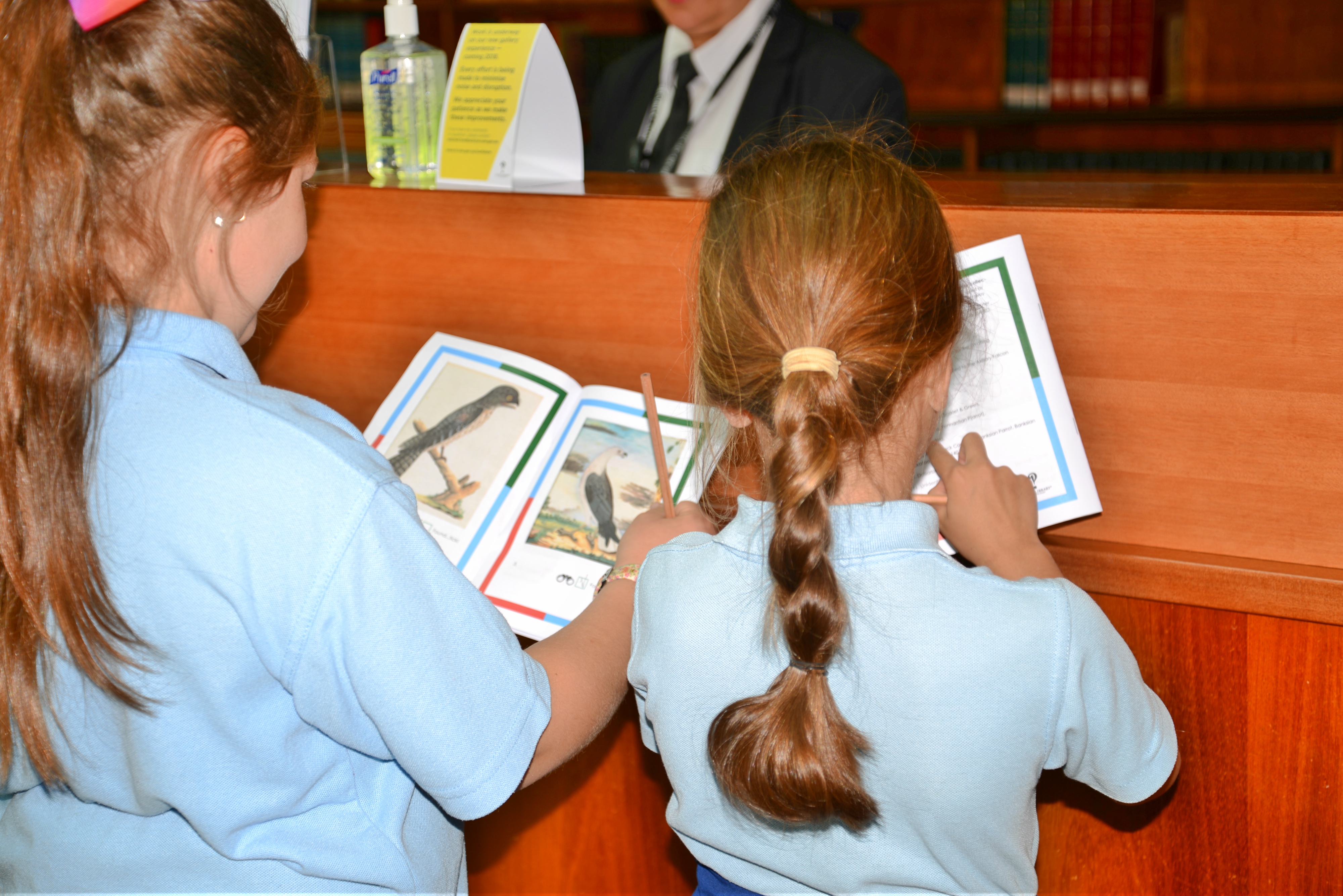 two students completing a notebook