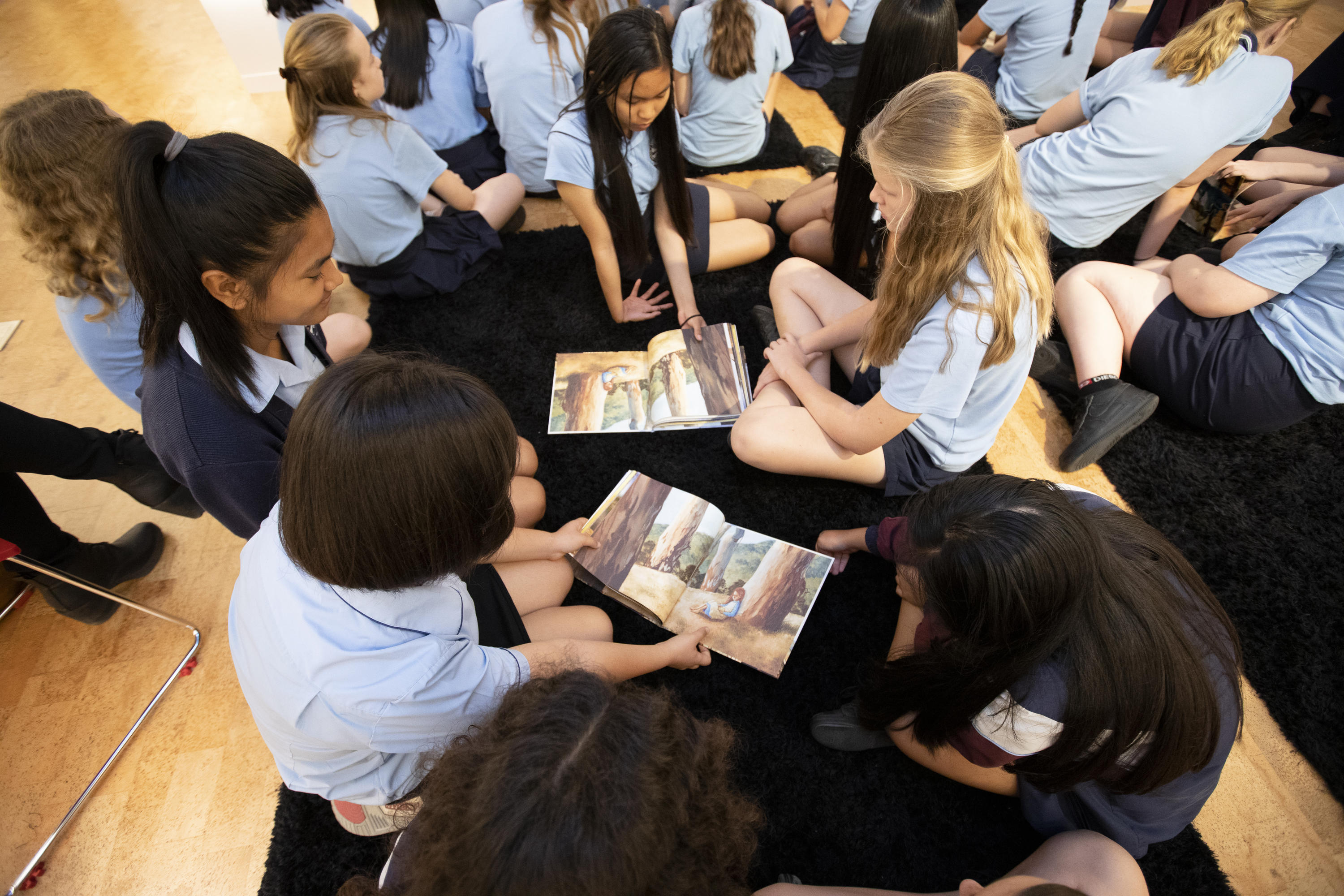 A group of students gathered around picture books