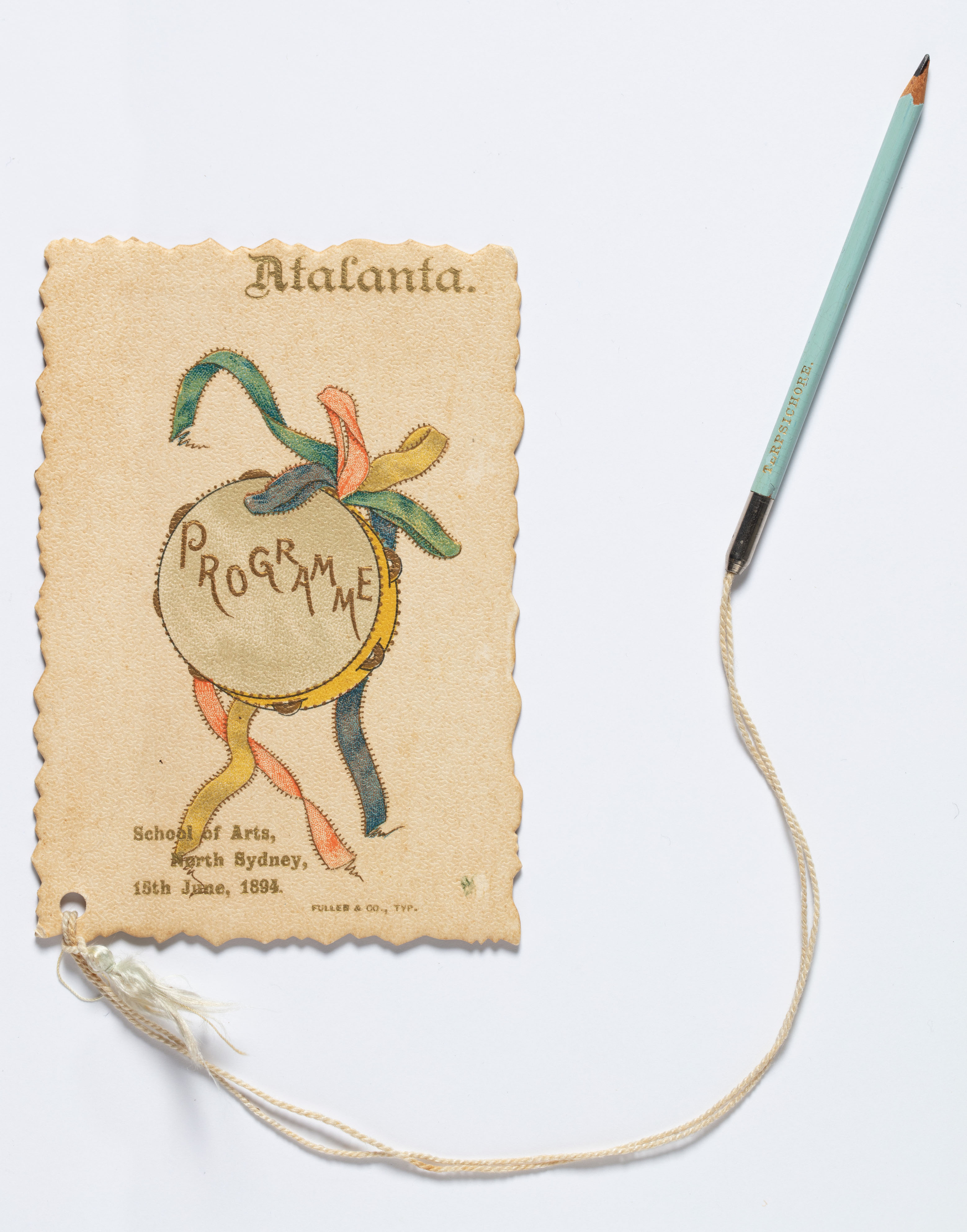 An illustrated card with a pencil attached via a string