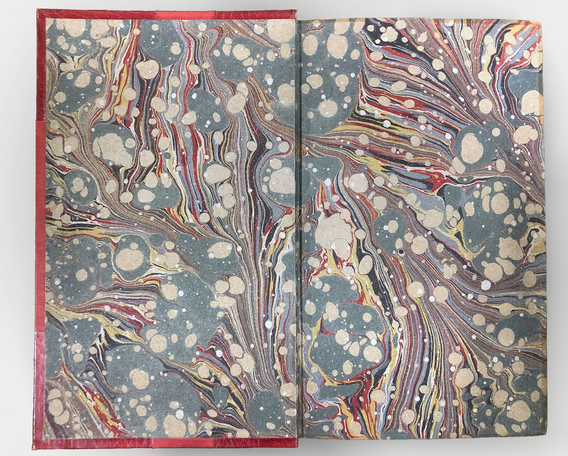 Endpapers with a colourful but dimmed marbled pattern.