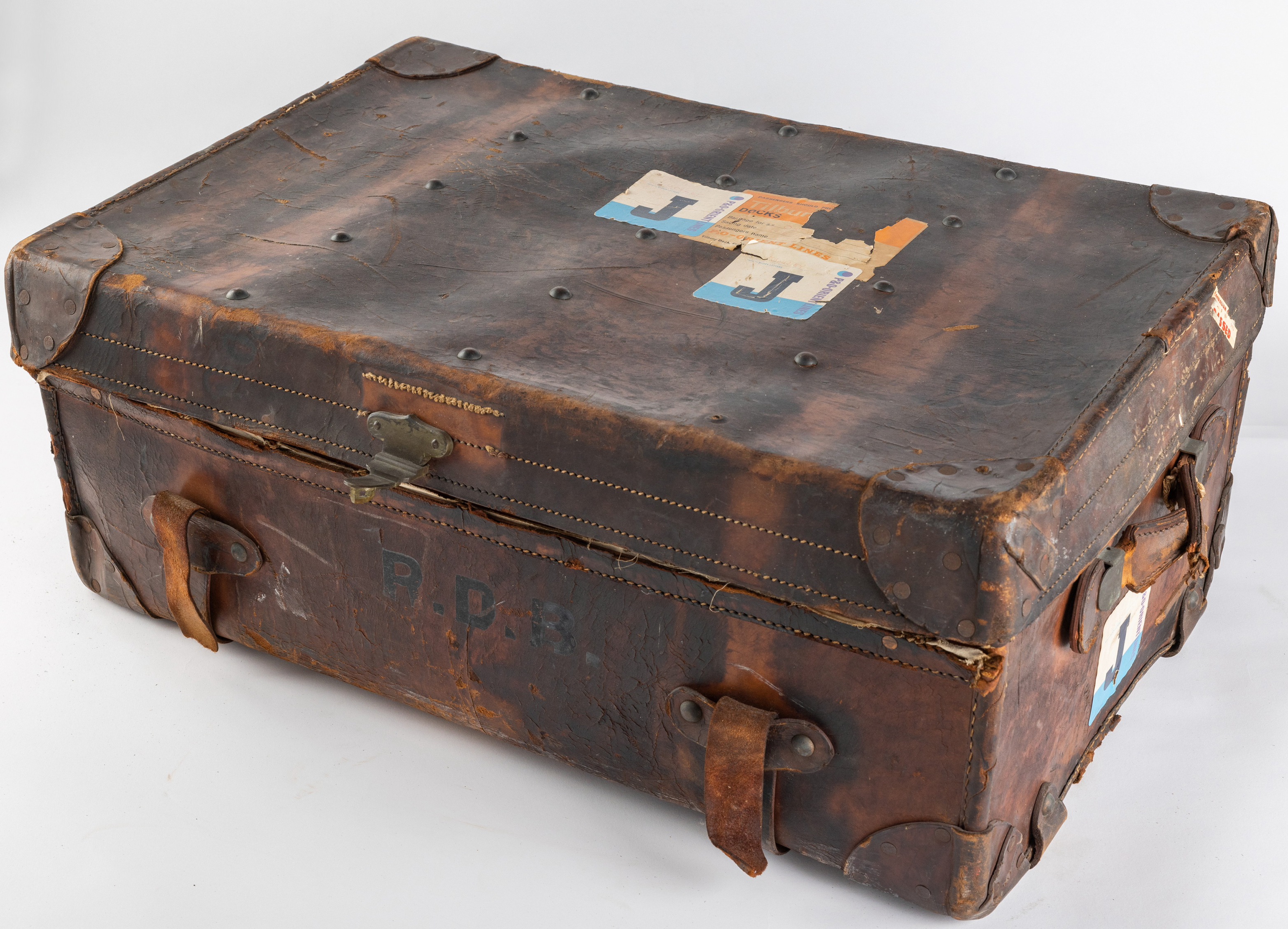 An old brown suitcase with two thick leather straps. 