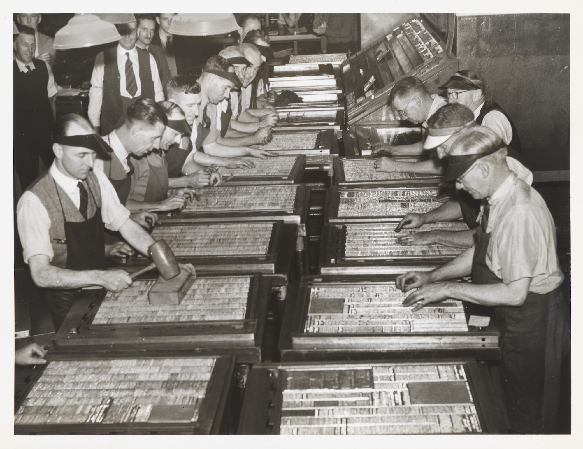 Sydney Morning Herald typesetters preparing the paper, with news rather than advertisements appearing on the front page for the first time, 1944