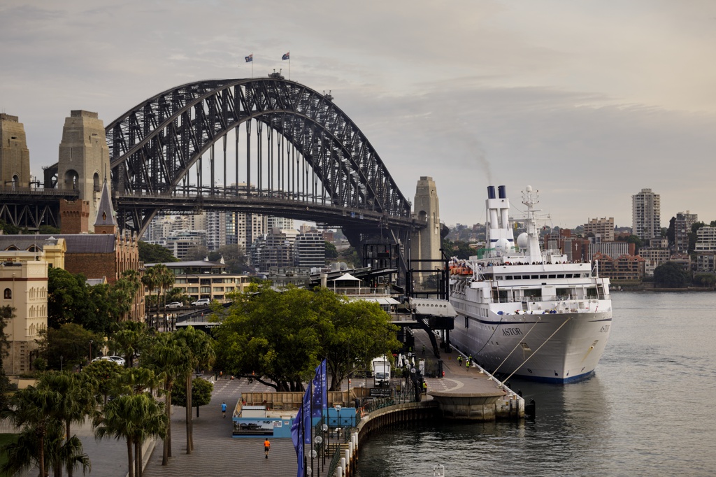 photograph of sydney harbour bridge with cruise ship in foreground