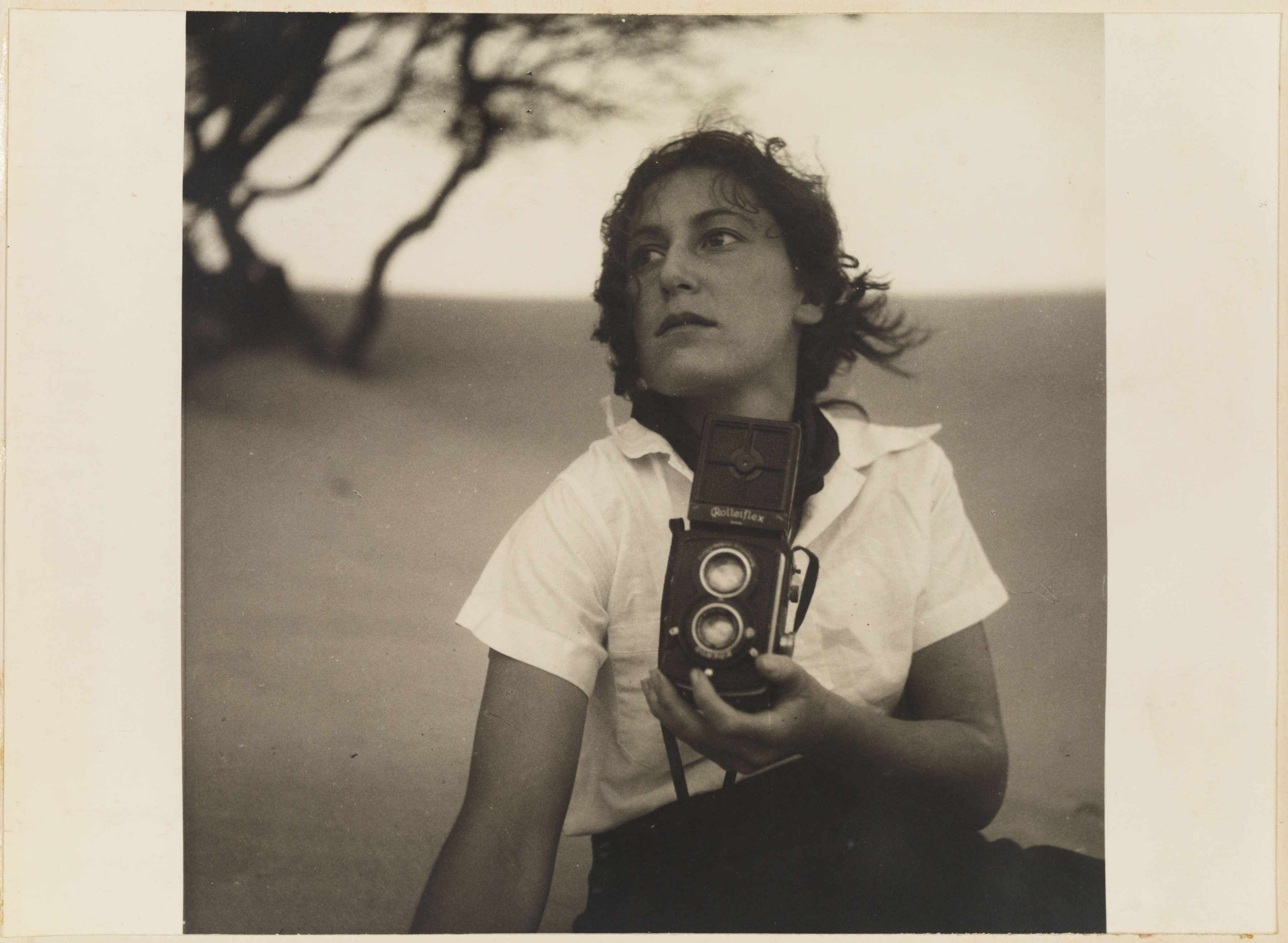17. Olive Cotton, holding camera