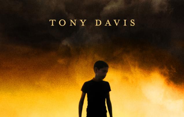 Boy standing with a building behind him on cover of The Big Dry by Tony Davis