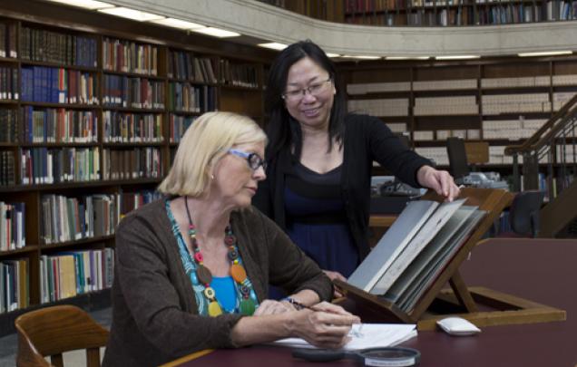 Staff and client using special collections material