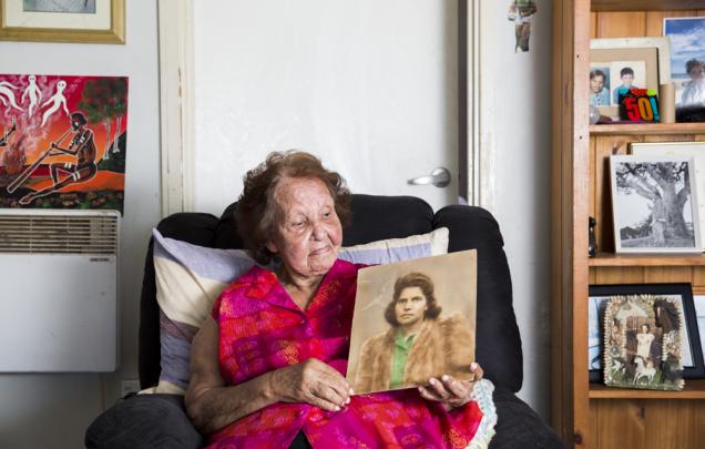 Woman holding sepia photograph