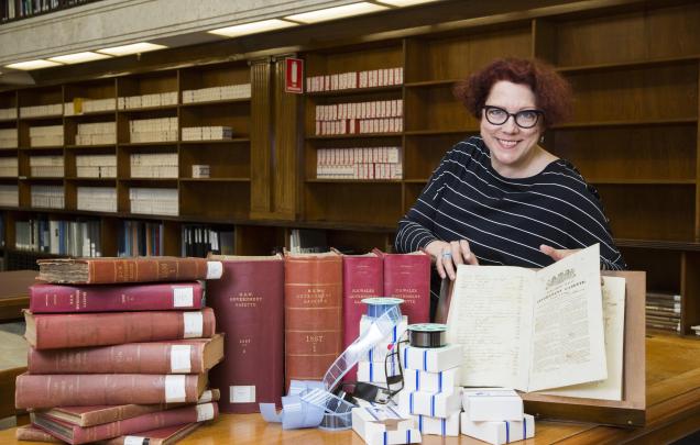 Curator Margot Margot Riley with NSW Government Gazettes 
