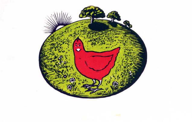 A red hen in a green landscape 