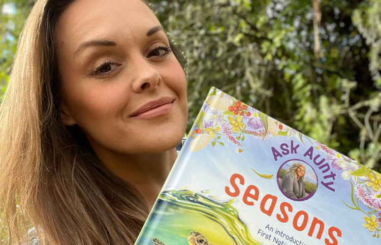  author Charmaine Ledden-Lewis posing with her book Ask Aunty: Seasons