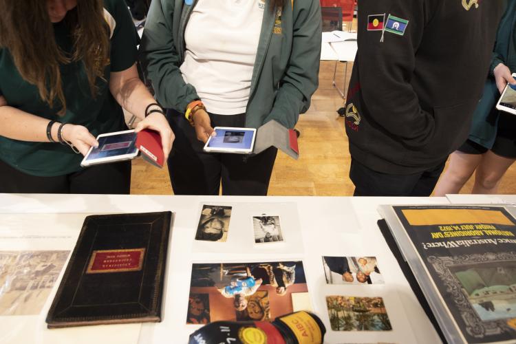 high school kids using ipads with first nations artifacts