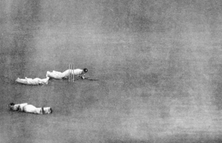 Black and white photo of cricket players dodging air attacks