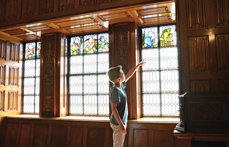Boy pointing at a stained glass window