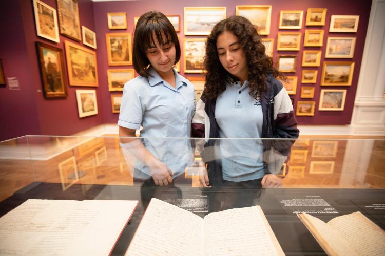 Two students looking at exhibition case