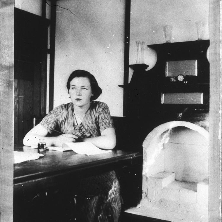Black and white photo of woman sitting at table