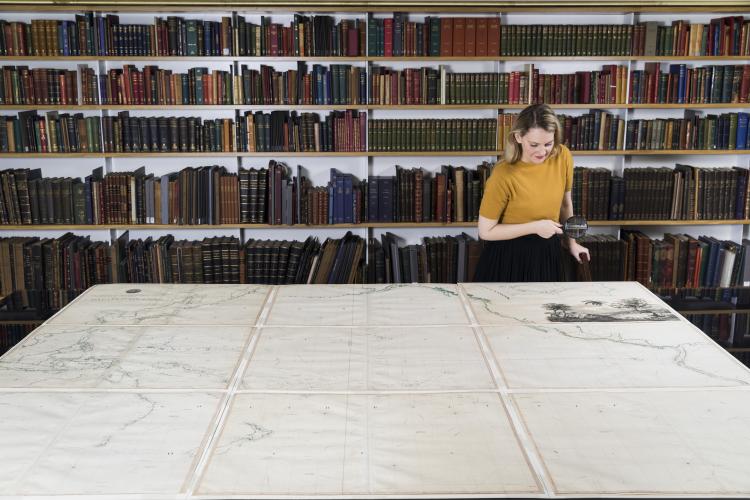 Alice Tonkinson examines the Arrowship map of the Pacific from 1798, photo by Joy Lai