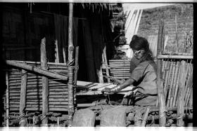 Apatani woman weaving on her porch