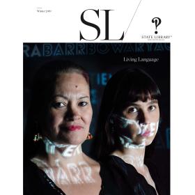 Magazine cover featuring two women with text projected in light.