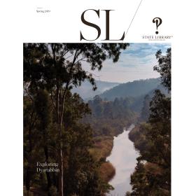 Magazine cover with a photograph of a river landscape through trees.