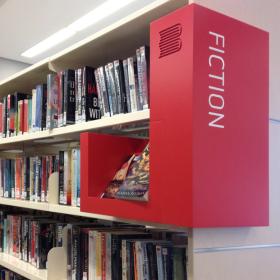 Library shelves with collection signage