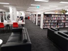 Internal view of library with lounge seats and bookshelves