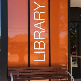 External library sign with seat
