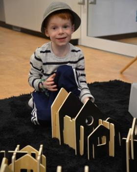 A boy playing with wooden blocks.