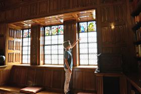 Boy pointing at a stained glass window