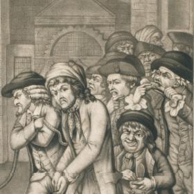 A group of men, all wearing hats and coats, with angry expressions on their faces