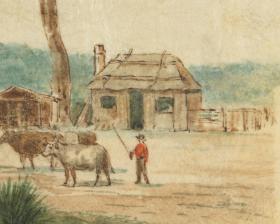 A house with man and cow in front