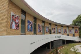 Large photos on external brick walls of a building